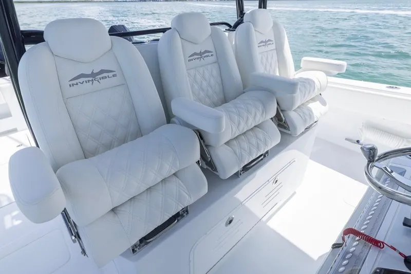  Yacht Photos Pics Luxurious seating on 2026 Invincible 36 Catamaran, featuring plush white upholstery and armrests.