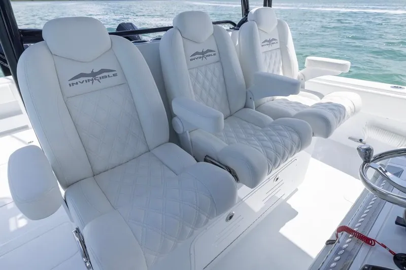  Yacht Photos Pics Luxurious seating on 2026 Invincible 36 Catamaran, featuring elegant white upholstery and ocean backdrop.