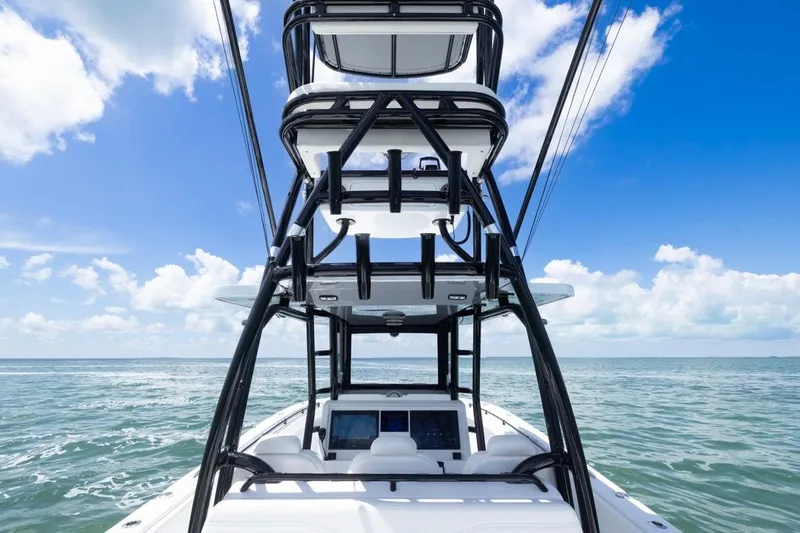  Yacht Photos Pics 2026 Invincible 36 Catamaran on open sea under clear blue sky.