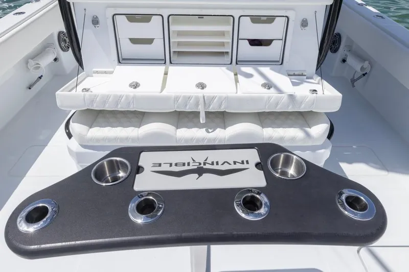  Yacht Photos Pics 2026 Invincible 36 Catamaran interior with seating and cup holders, showcasing luxury design.