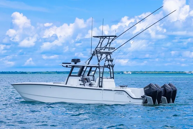  Yacht Photos Pics 2026 Invincible 36 Catamaran on open water, featuring triple outboard engines.