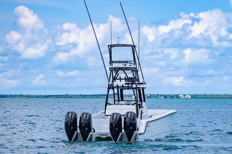  Yacht Photos Pics 2026 Invincible 36 Catamaran with four engines on open water under blue sky.