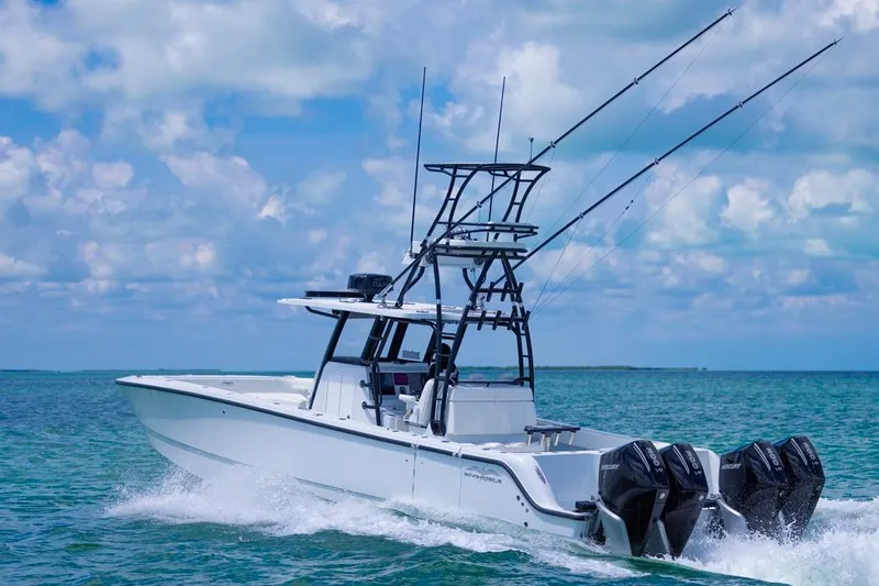  Yacht Photos Pics 2026 Invincible 36 Catamaran cruising on clear blue ocean waters.