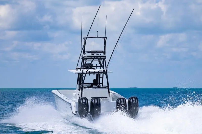  Yacht Photos Pics 2026 Invincible 36 Catamaran cruising on open ocean with powerful engines.