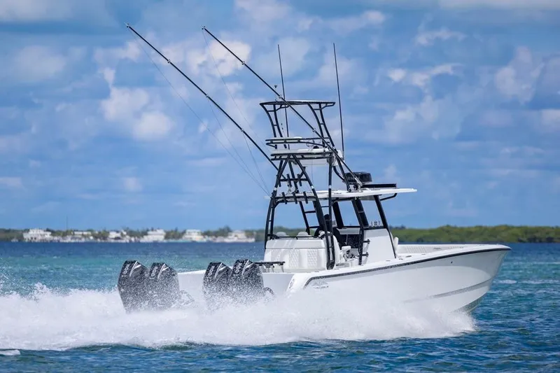  Yacht Photos Pics 2026 Invincible 36 Catamaran speeding on blue ocean waters under a clear sky.
