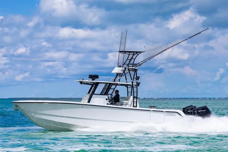  Yacht Photos Pics 2026 Invincible 36 Catamaran cruising on open water under a cloudy sky.