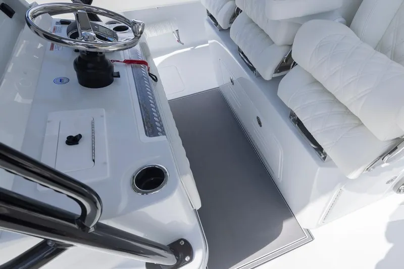  Yacht Photos Pics Interior of 2026 Invincible 36 Catamaran with steering wheel and cushioned seating.