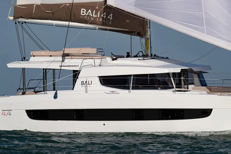 Yacht Photos Pics 2025 Bali 4.4 catamaran sailing on open water, showcasing sleek design and spacious deck.