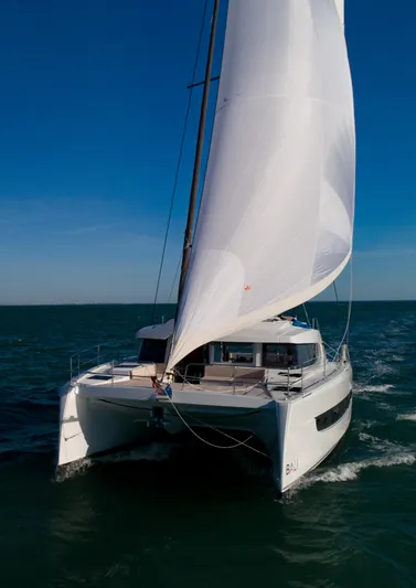  Yacht Photos Pics Sailing catamaran Bali 4.4, 2025 model, gliding on open sea under clear blue sky.