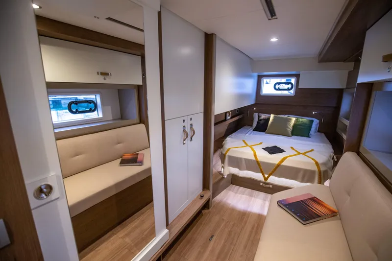  Yacht Photos Pics Luxurious interior of 2025 Bali 4.4 yacht with cozy bedroom and seating area.