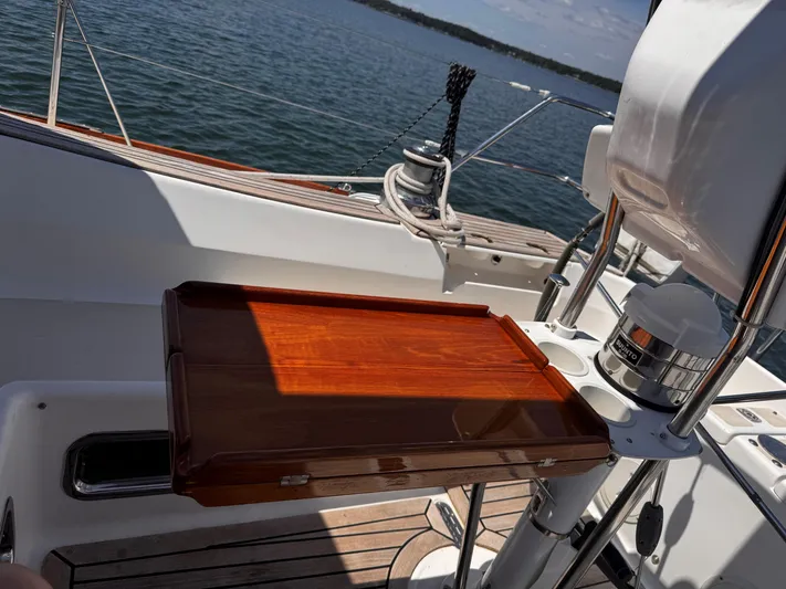 Dawn Treader Yacht Photos Pics Tartan 3700 Keel/Centerboard sailboat cockpit with wooden table, 2005 model, on calm water.