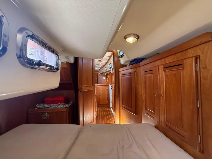 Dawn Treader Yacht Photos Pics Interior of 2005 Tartan 3700 Keel/Centerboard sailboat with wooden cabinetry and cozy sleeping area.