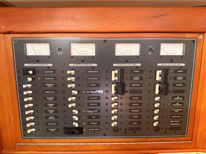 Dawn Treader Yacht Photos Pics Electrical control panel on a 2005 Tartan 3700 Keel/Centerboard sailboat, featuring various switches and meters.