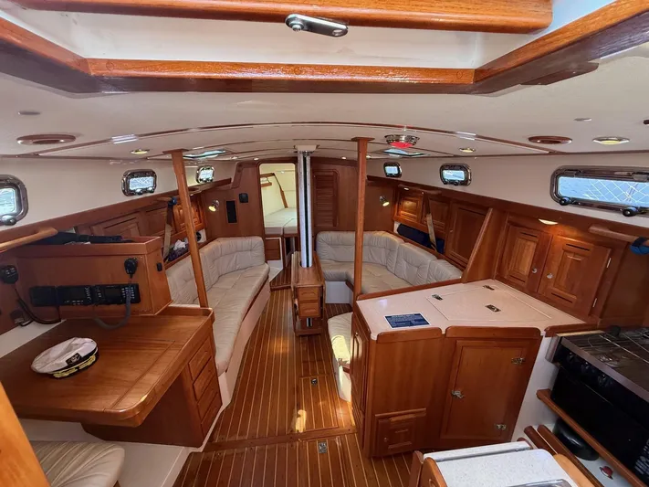 Dawn Treader Yacht Photos Pics Interior of 2005 Tartan 3700 Keel/Centerboard sailboat with wooden furnishings and seating.