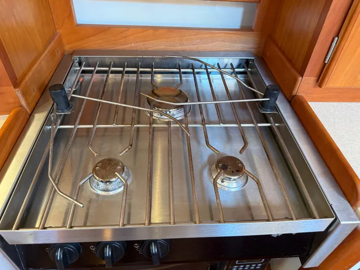 Dawn Treader Yacht Photos Pics Stainless steel stove with three burners in a Tartan 3700 Keel/Centerboard yacht kitchen.