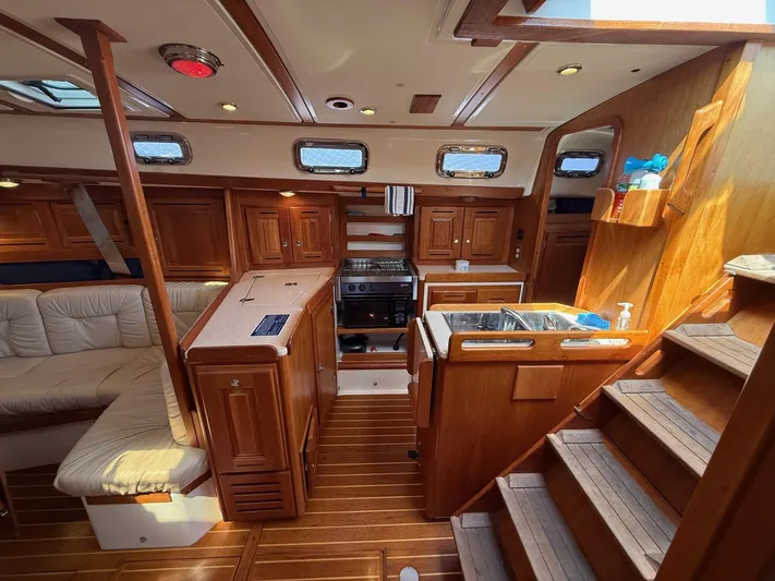 Dawn Treader Yacht Photos Pics Interior of 2005 Tartan 3700 Keel/Centerboard sailboat with wooden cabinetry and seating.