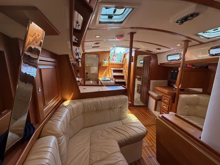 Dawn Treader Yacht Photos Pics Luxurious interior of 2005 Tartan 3700 Keel/Centerboard sailboat with wood finish and plush seating.