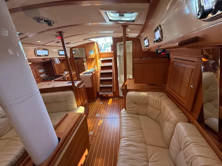 Dawn Treader Yacht Photos Pics Luxurious interior of a 2005 Tartan 3700 Keel/Centerboard sailboat with wood finishes and leather seating.