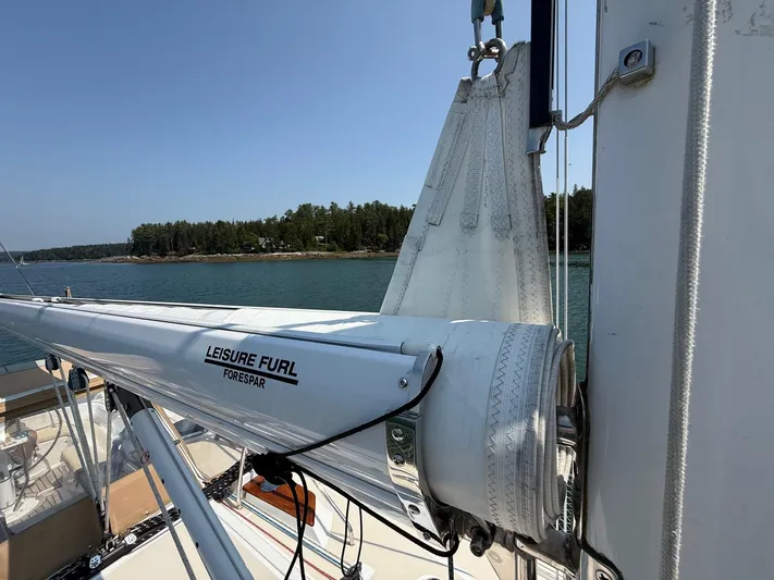 Dawn Treader Yacht Photos Pics Sailboat with Leisure Furl system, Tartan 3700 Keel/Centerboard, 2005, docked by a forested shoreline.