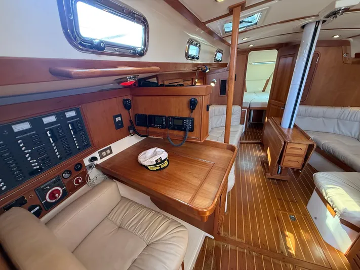 Dawn Treader Yacht Photos Pics Interior of 2005 Tartan 3700 Keel/Centerboard sailboat with wood finish and navigation station.