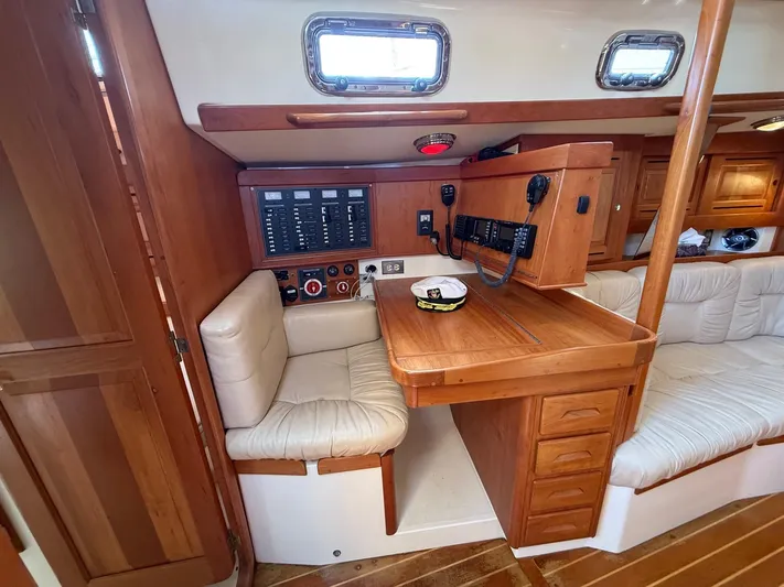 Dawn Treader Yacht Photos Pics Interior of 2005 Tartan 3700 Keel/Centerboard sailboat with navigation station and seating.