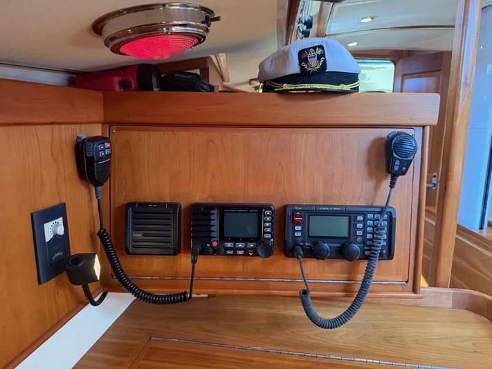 Dawn Treader Yacht Photos Pics Interior of 2005 Tartan 3700 sailboat with communication equipment and captain's hat.