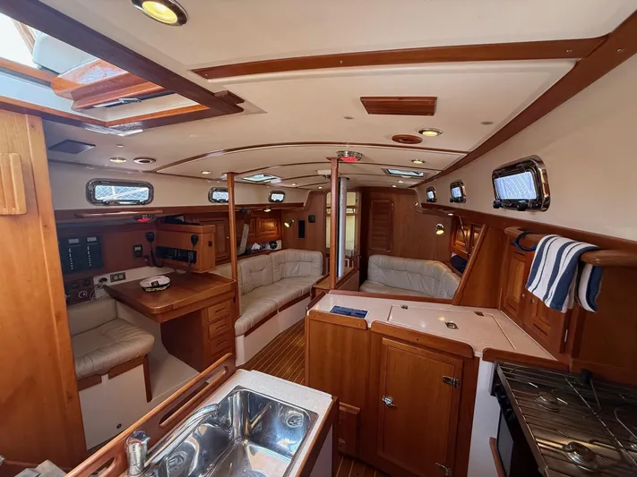 Dawn Treader Yacht Photos Pics Interior of 2005 Tartan 3700 Keel/Centerboard sailboat with wood finish and seating area.