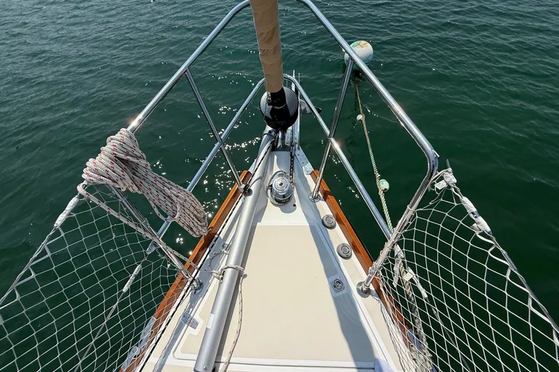 Dawn Treader Yacht Photos Pics Bow of 2005 Tartan 3700 Keel/Centerboard sailboat with ropes and railing on water.