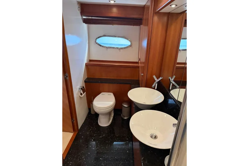  Yacht Photos Pics Luxurious bathroom in 2006 Sunseeker Predator 82 yacht with modern fixtures and elegant design.