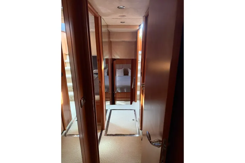  Yacht Photos Pics Interior hallway of 2006 Sunseeker Predator 82 yacht, featuring wood paneling and carpeted flooring.
