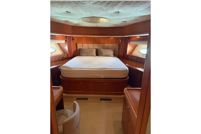  Yacht Photos Pics Luxurious cabin interior of 2006 Sunseeker Predator 82 yacht with elegant wood finish.