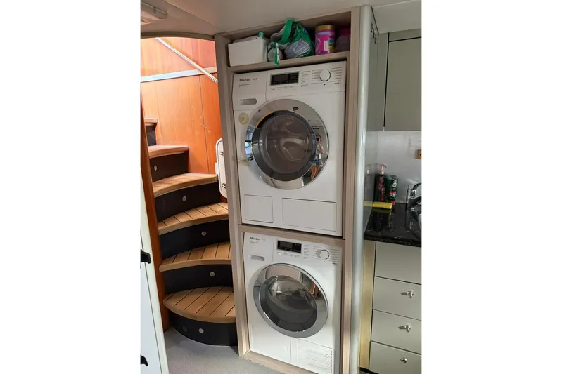  Yacht Photos Pics Laundry area with stacked washer and dryer on a 2006 Sunseeker Predator 82 yacht.
