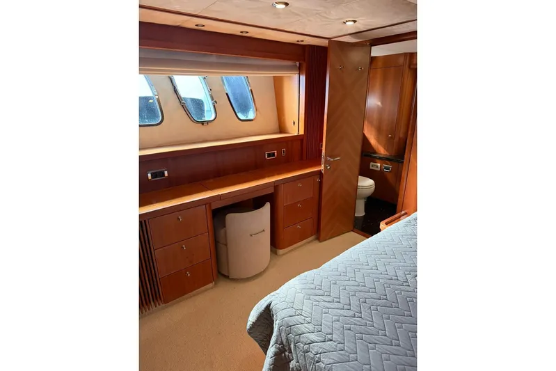  Yacht Photos Pics Luxurious cabin interior of 2006 Sunseeker Predator 82 yacht with wood furnishings.