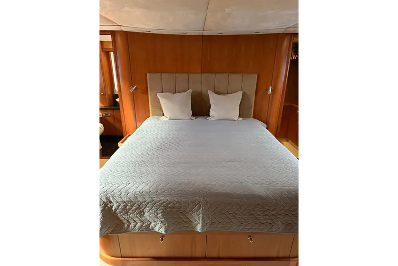  Yacht Photos Pics Luxurious bedroom interior of 2006 Sunseeker Predator 82 yacht with elegant bedding.