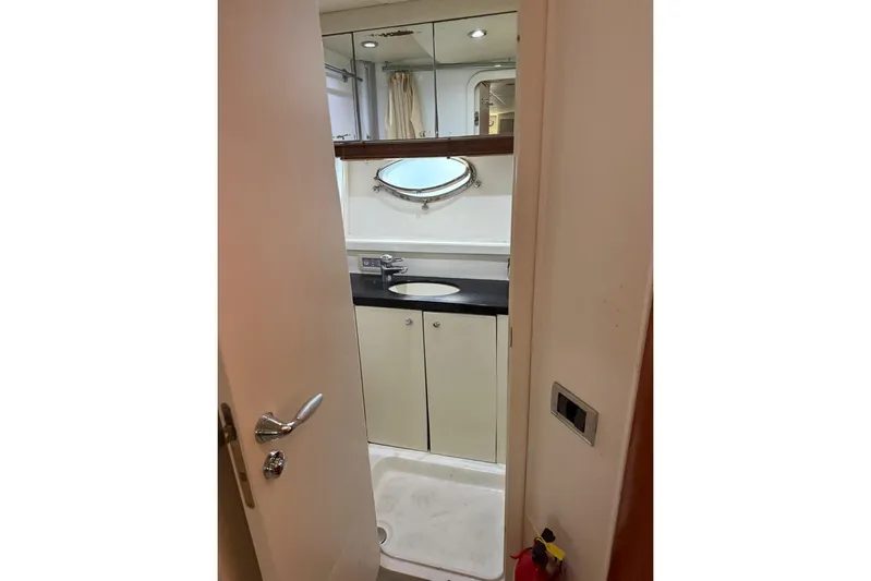  Yacht Photos Pics Bathroom interior of 2006 Sunseeker Predator 82 yacht, featuring sink and mirror.