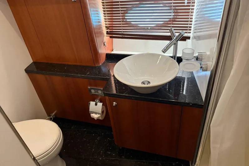  Yacht Photos Pics Luxurious bathroom in 2006 Sunseeker Predator 82 yacht with modern sink and wooden cabinetry.