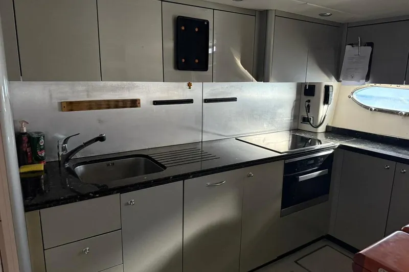  Yacht Photos Pics Modern kitchen interior on a 2006 Sunseeker Predator 82 yacht, featuring sleek cabinetry and appliances.