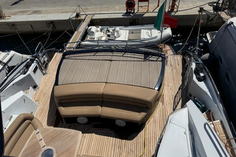  Yacht Photos Pics Luxury Sunseeker Predator 82 yacht deck, 2006 model, with seating and tender boat.