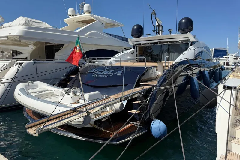  Yacht Photos Pics Sunseeker Predator 82 yacht, 2006 model, docked with Portuguese flag, featuring a small tender.