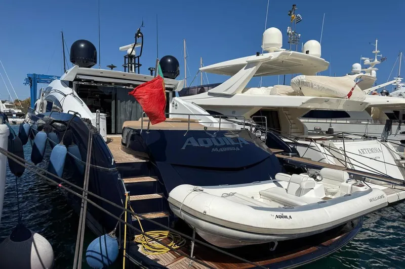  Yacht Photos Pics Luxury Sunseeker Predator 82 yacht, 2006 model, docked with inflatable boat on deck.