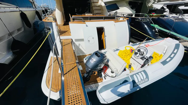  Yacht Photos Pics Luxury Canados 76 yacht with Novurania tender, docked, showcasing elegant teak decking, 2016 model.