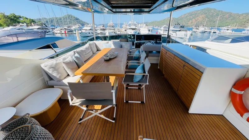  Yacht Photos Pics Luxurious 2016 Canados 76 yacht deck with elegant seating and scenic marina view.