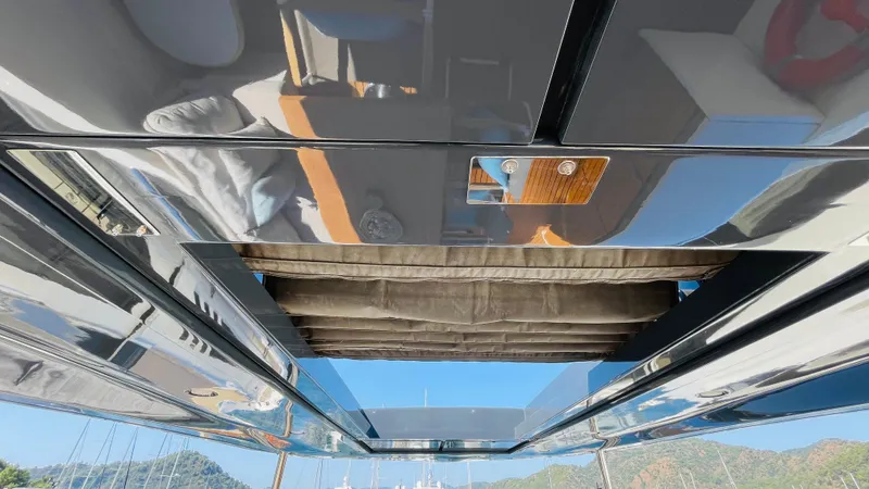  Yacht Photos Pics Sleek interior of 2016 Canados 76 yacht with reflective surfaces and modern design.