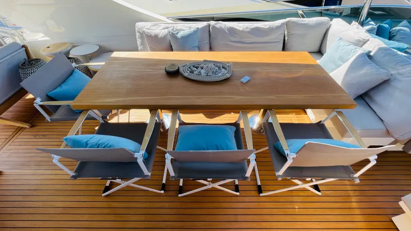  Yacht Photos Pics Luxury Canados 76 yacht deck with wooden table, chairs, and cushions, 2016 model.