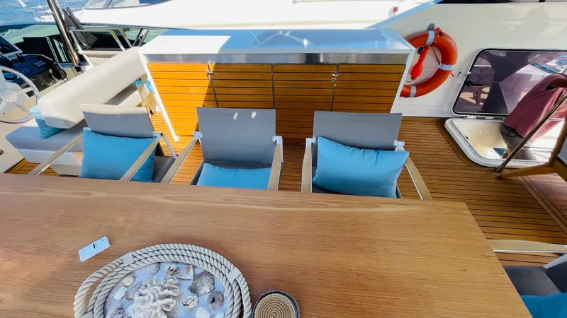  Yacht Photos Pics Luxurious Canados 76 yacht deck with seating, table, and life preserver, 2016 model.