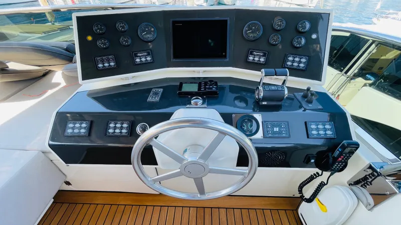 Yacht Photos Pics Helm of 2016 Canados 76 yacht with modern navigation controls and wooden flooring.