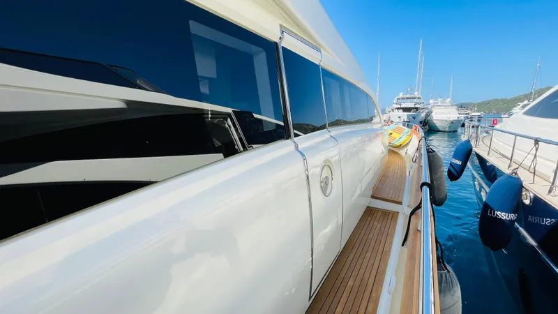  Yacht Photos Pics Luxury Canados 76 yacht docked, showcasing sleek design and wooden deck, 2016 model.