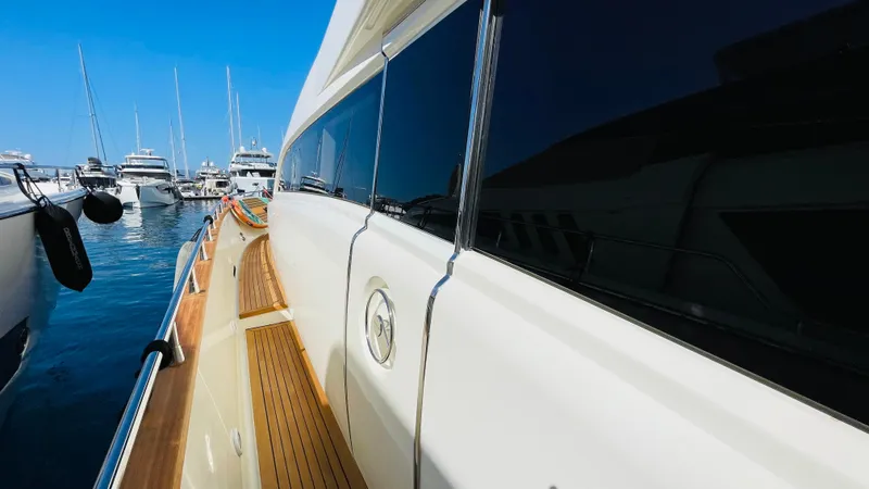  Yacht Photos Pics Luxury Canados 76 yacht docked at marina, showcasing sleek design and wooden deck, 2016 model.