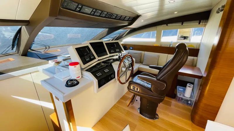  Yacht Photos Pics Luxurious helm of 2016 Canados 76 yacht with leather captain's chair and modern controls.