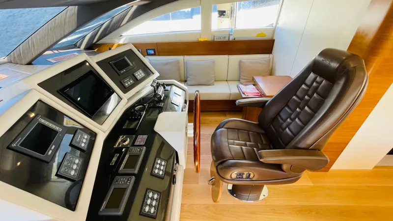  Yacht Photos Pics Luxurious helm station of 2016 Canados 76 yacht with leather captain's chair and navigation controls.